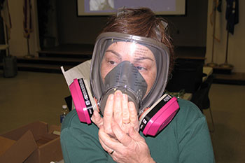 A woman tries on a mask